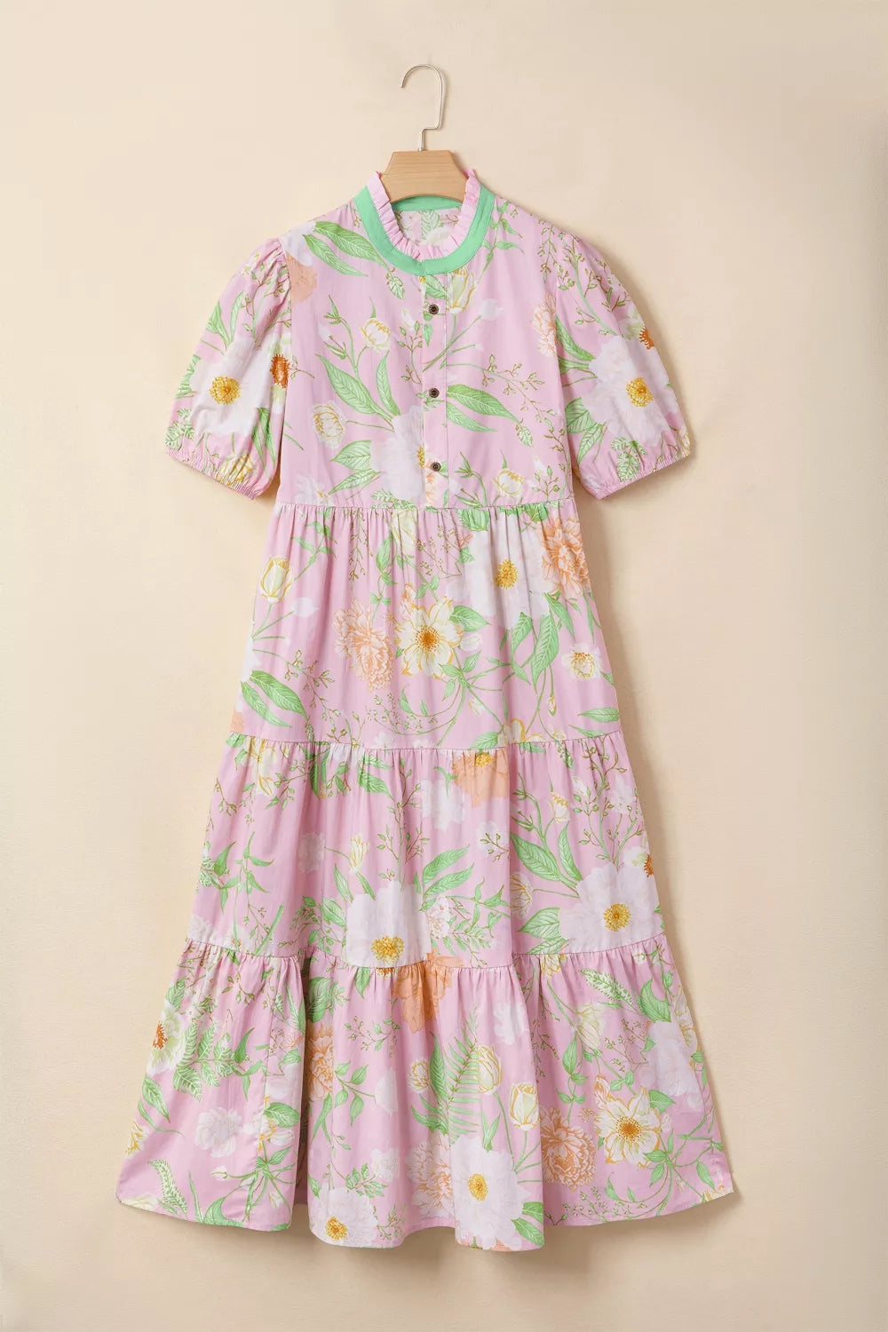 Pink floral tiered cotton dress with puff sleeves and ruffled collar.