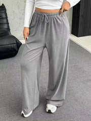 Maternity wide-leg pants in light gray with drawstring waist and relaxed fit.