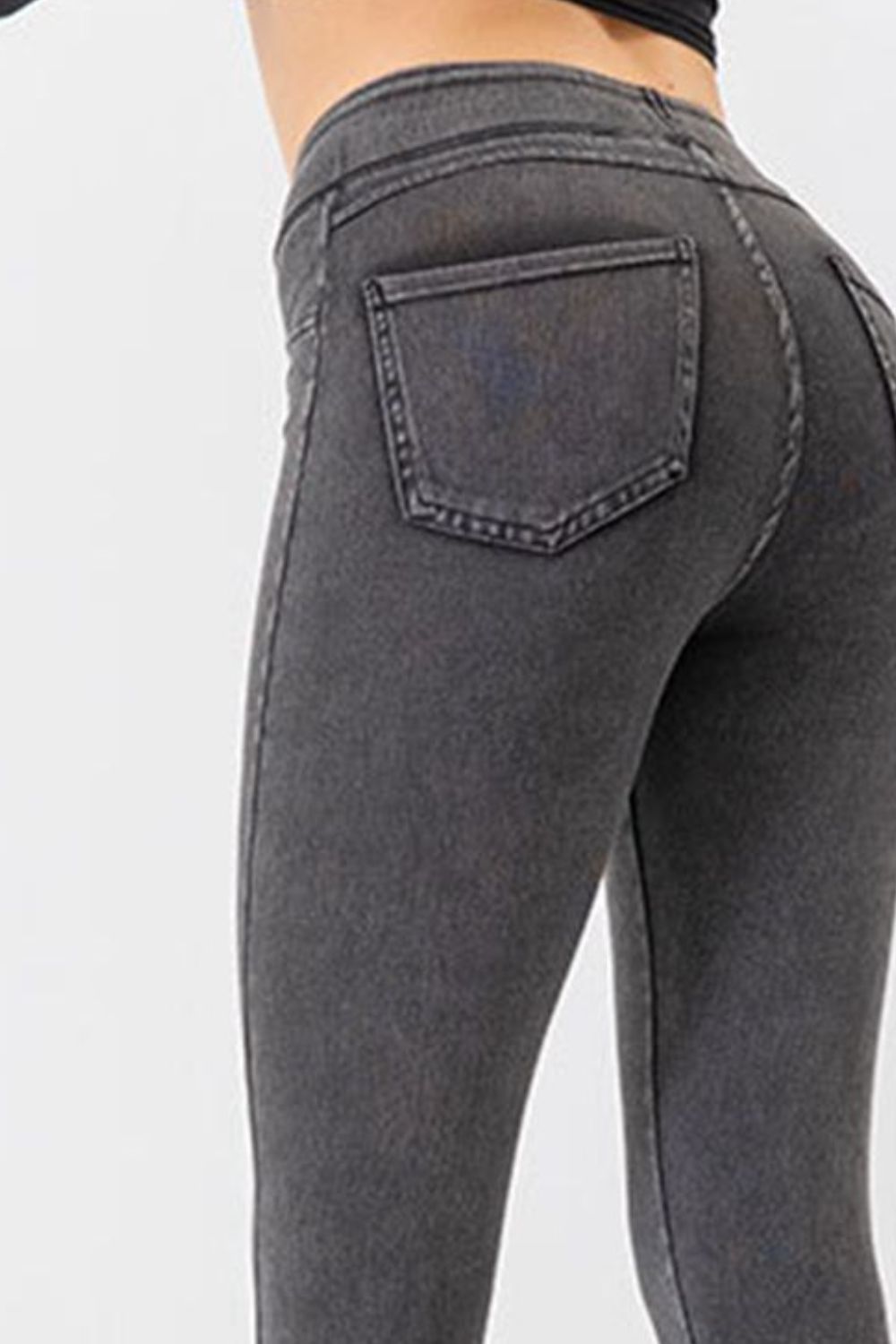 Dark gray denim-effect leggings with a sculpted fit and back pocket detail.