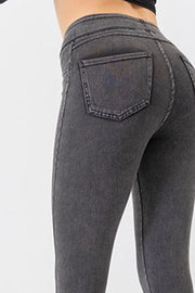 Dark gray denim-effect leggings with a sculpted fit and back pocket detail.