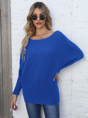 Blue ribbed dolman knit sweater with off-the-shoulder neckline and long sleeves.
