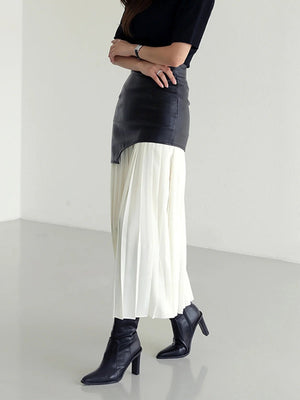 Black asymmetric leather midi skirt with white pleated chiffon overlay.
