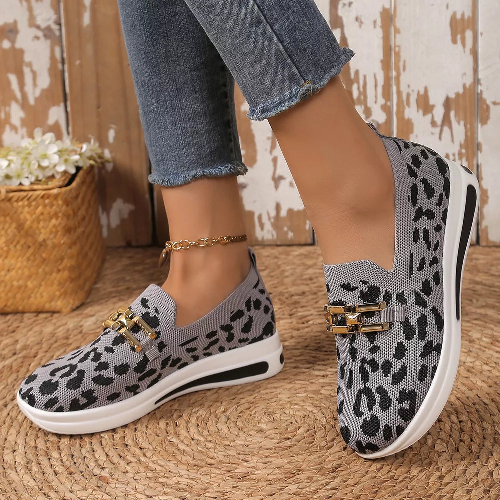 Gray leopard print mesh slip-on shoes with gold buckle detail and white sole.