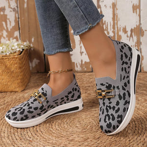 Gray leopard print mesh slip-on shoes with gold buckle detail and white sole.