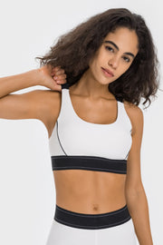 White sports bra with black trim and band, scoop neck, crossback detail