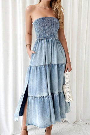 Light blue denim strapless tiered maxi dress with smocked bodice and side slits.