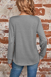 Gray long sleeve top with a square neckline and subtle pleating detail at the back.