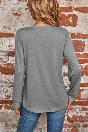 Gray long sleeve top with a square neckline and subtle pleating detail at the back.