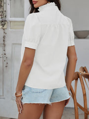 White seersucker blouse with puff sleeves and ruffled mock neck.