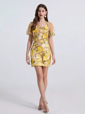 Yellow floral mini dress with puff sleeves and V-neck, featuring 3D applique flowers.