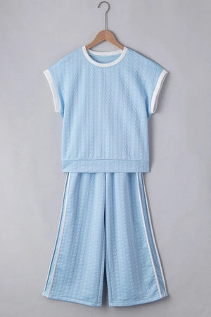 Light blue cable knit loungewear set with contrast trim on neckline, sleeves, and pants.