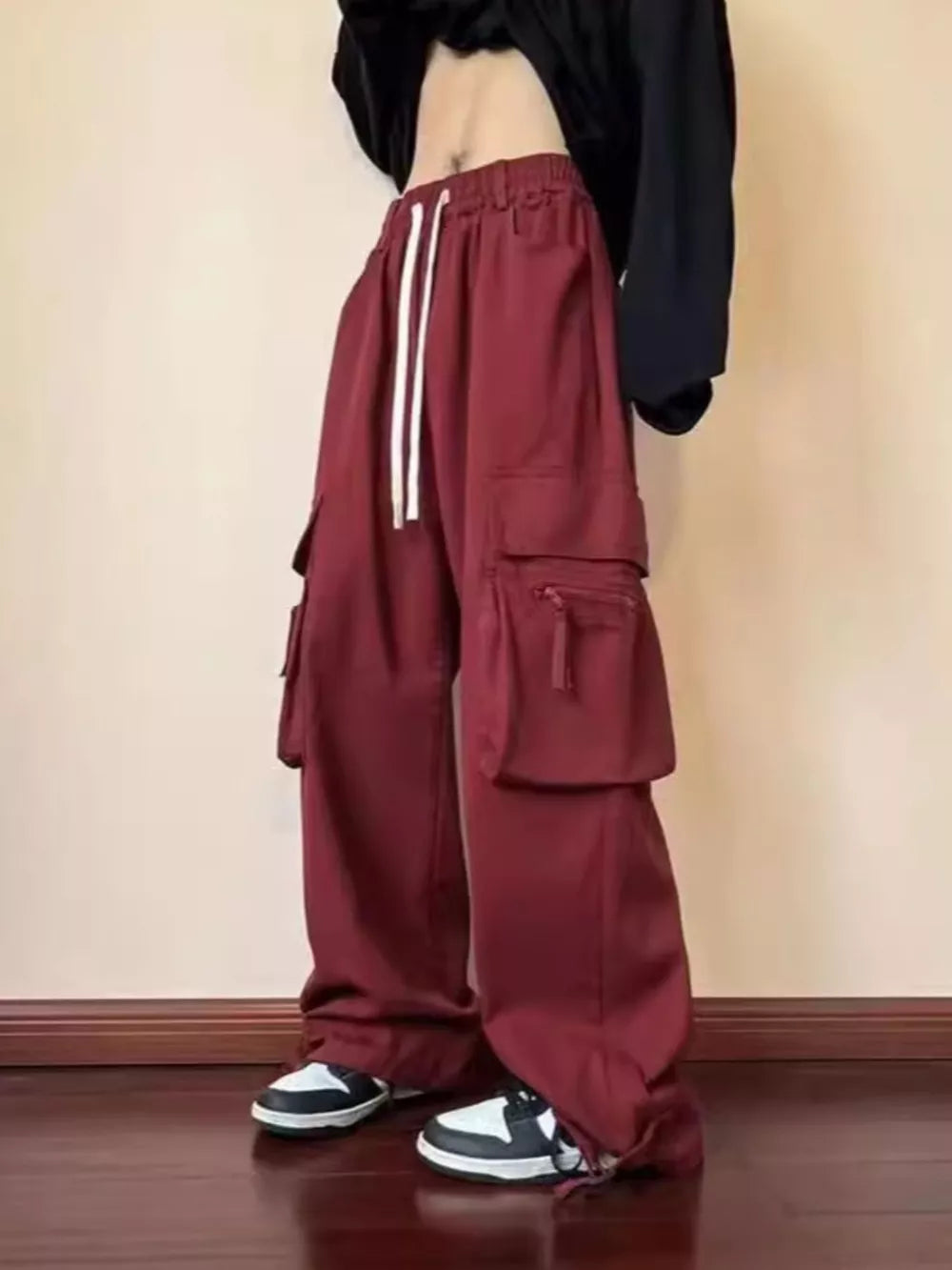 Burgundy relaxed fit cargo sweatpants with drawstring and multiple pockets.