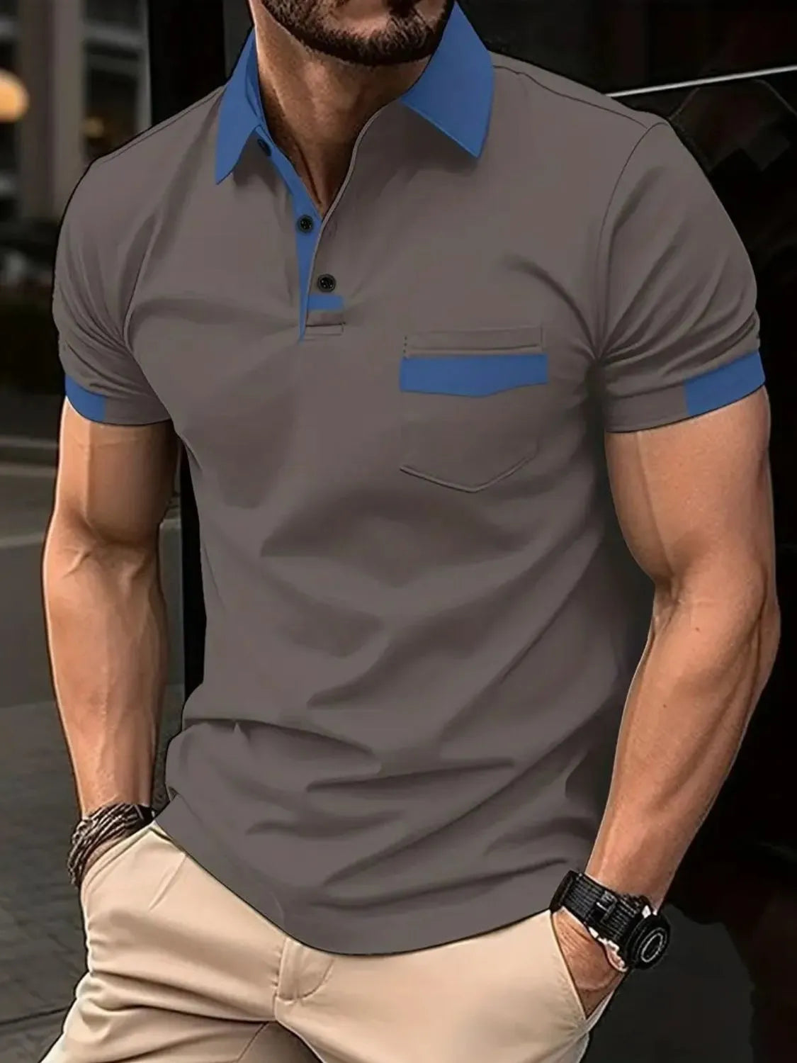 Color-blocked polo shirt in grey with blue collar, pocket detail, and sleeve trim.