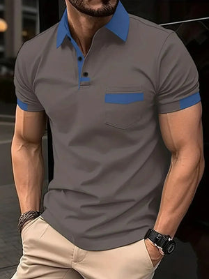 Color-blocked polo shirt in grey with blue collar, pocket detail, and sleeve trim.