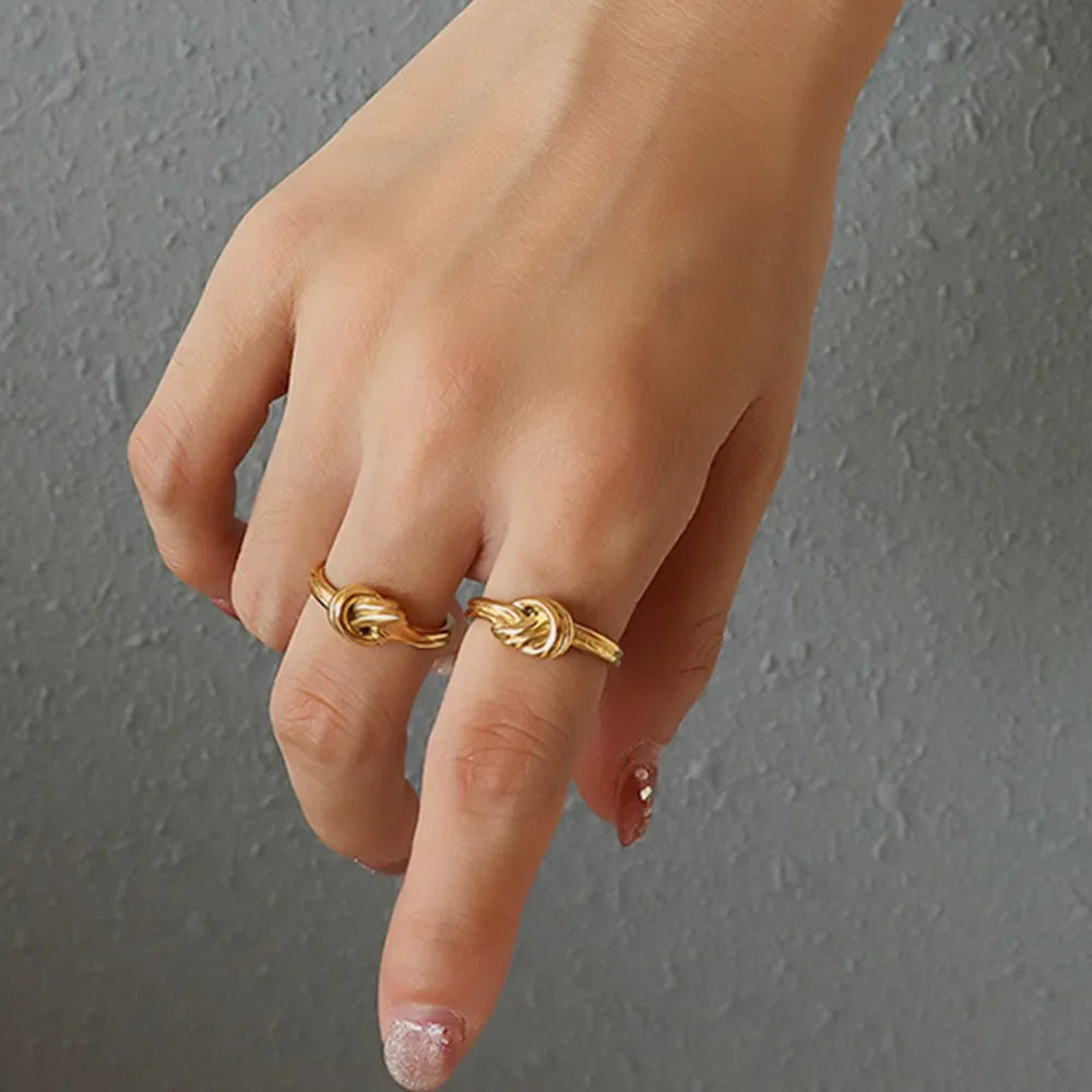 Gold knot detail sterling silver rings on hand