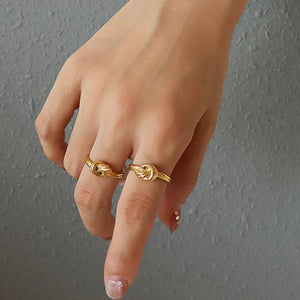 Gold knot detail sterling silver rings on hand