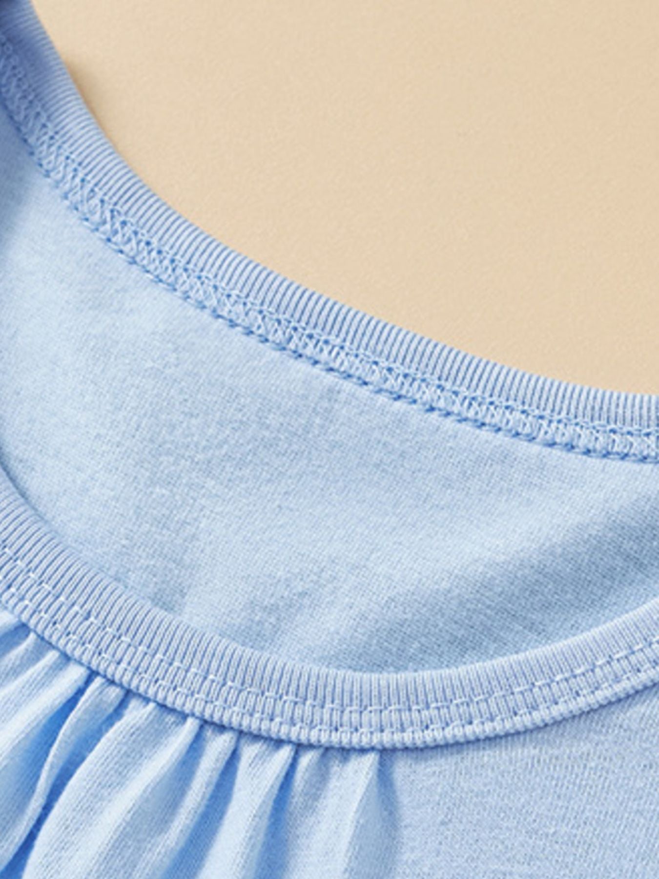 Light blue cotton toddler t-shirt with crew neck and ruffled detail.