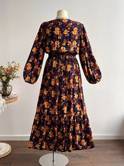 Maxi dress with V-neck, long balloon sleeves, and tiered skirt in a dark floral print.