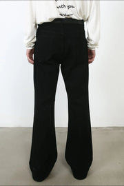 Black bootcut jeans with a flared leg, shown from the back.