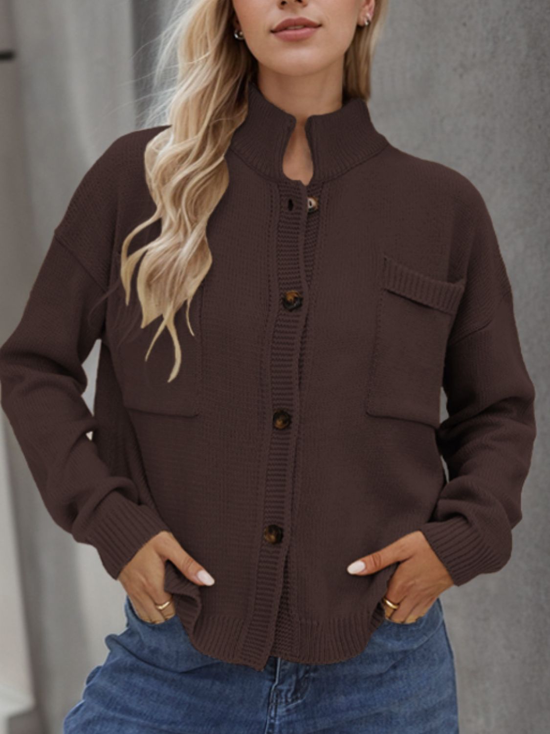 Coffee brown acrylic knit cardigan with stand collar, buttons, and two chest pockets.