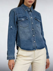 Blue denim overshirt with button-down front, chest pockets, and rolled sleeves.