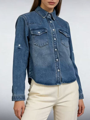 Blue denim overshirt with button-down front, chest pockets, and rolled sleeves.