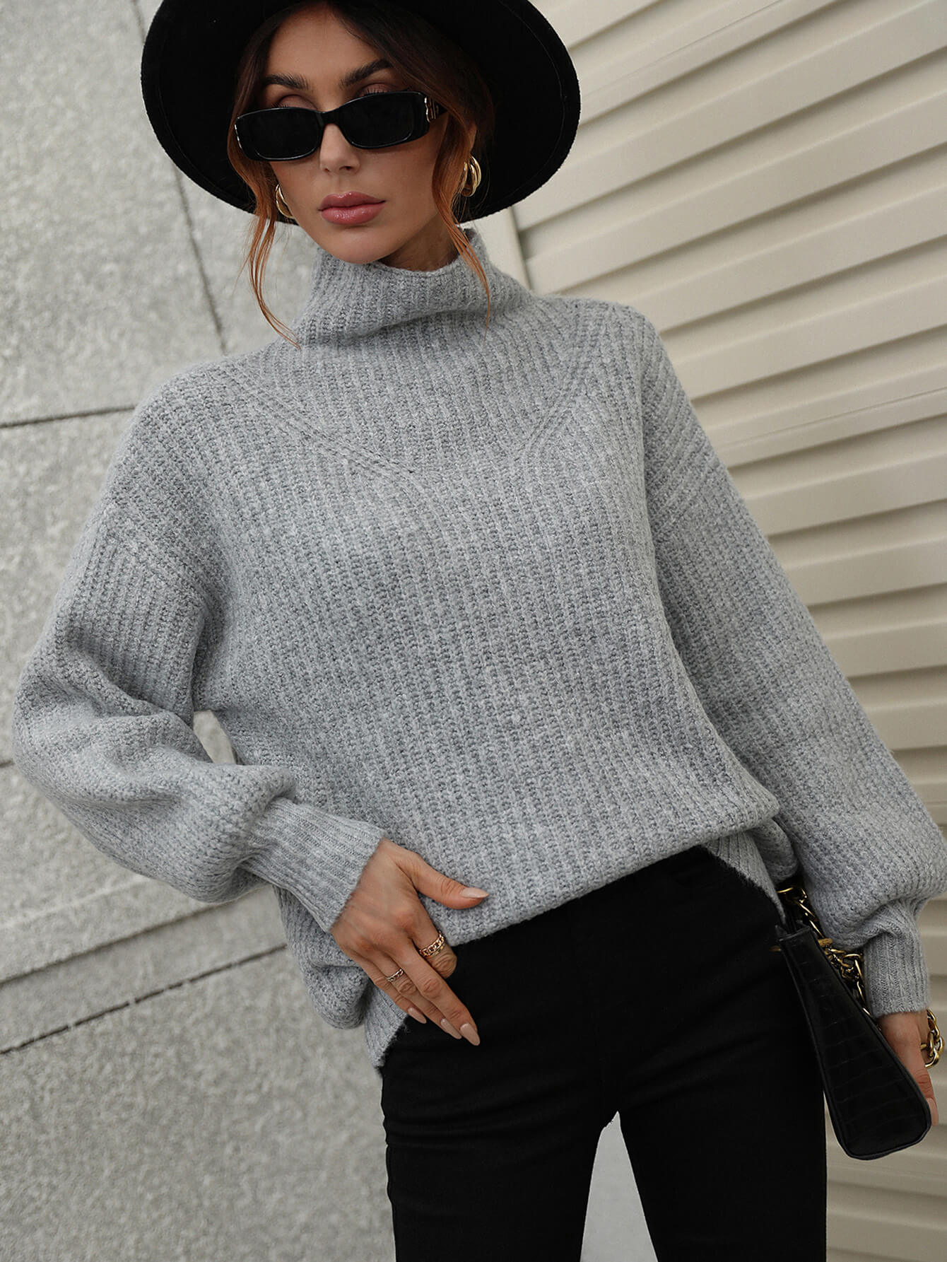 Gray ribbed knit turtleneck sweater with balloon sleeves and V-stitch detail.