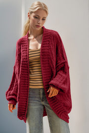 Deep Red textured bouclé cocoon cardigan with balloon sleeves and open front.