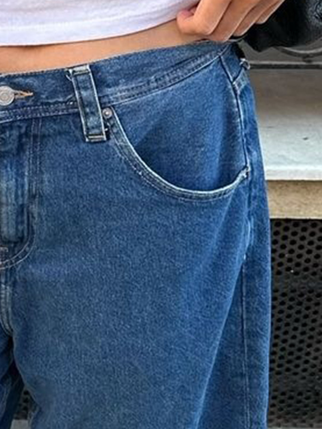 Culotte-cut denim bermuda shorts in Dusty Blue with button closure and pocket detail.