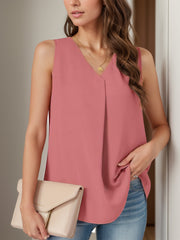 Sleeveless dusty pink blouse with V-neck and front pleats, paired with jeans and a clutch.