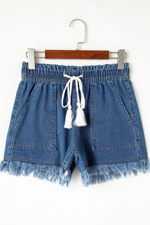Navy denim drawstring shorts with frayed hem and tassel detail