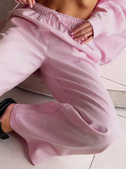 Pink relaxed fit two-piece set outfit with elastic waistband pants and button-up shirt detail.
