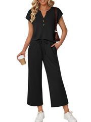 Black notched V-neck top with drawstring wide-leg pants set.