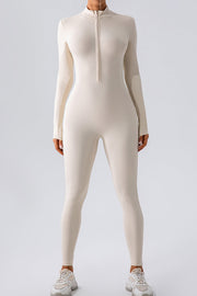 Sculpted zip-front bodycon jumpsuit in white with long sleeves and a mock neck.