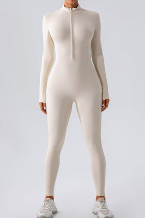 Sculpted zip-front bodycon jumpsuit in white with long sleeves and a mock neck.