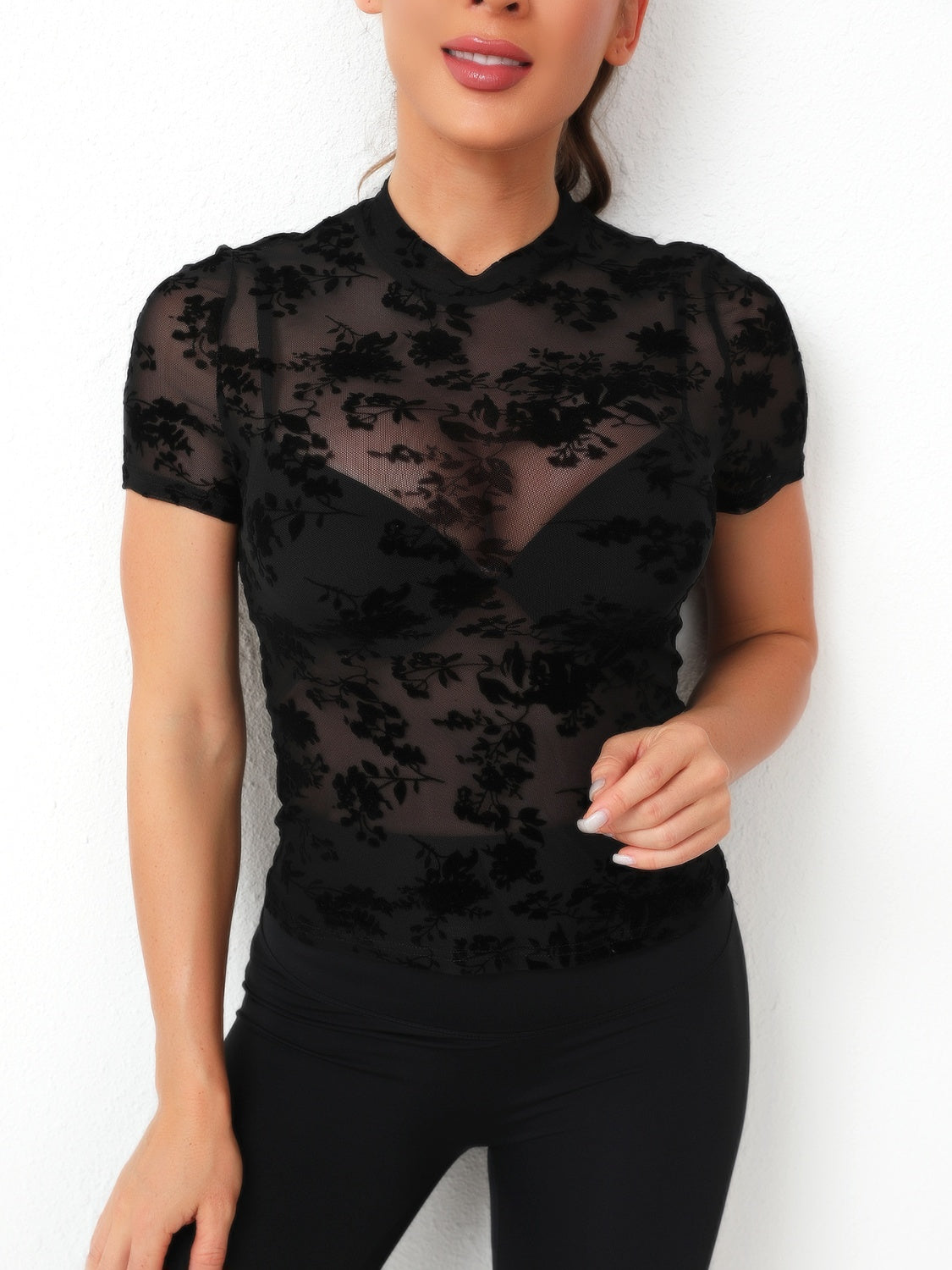 Black velvet floral mesh mock neck top with short sleeves.