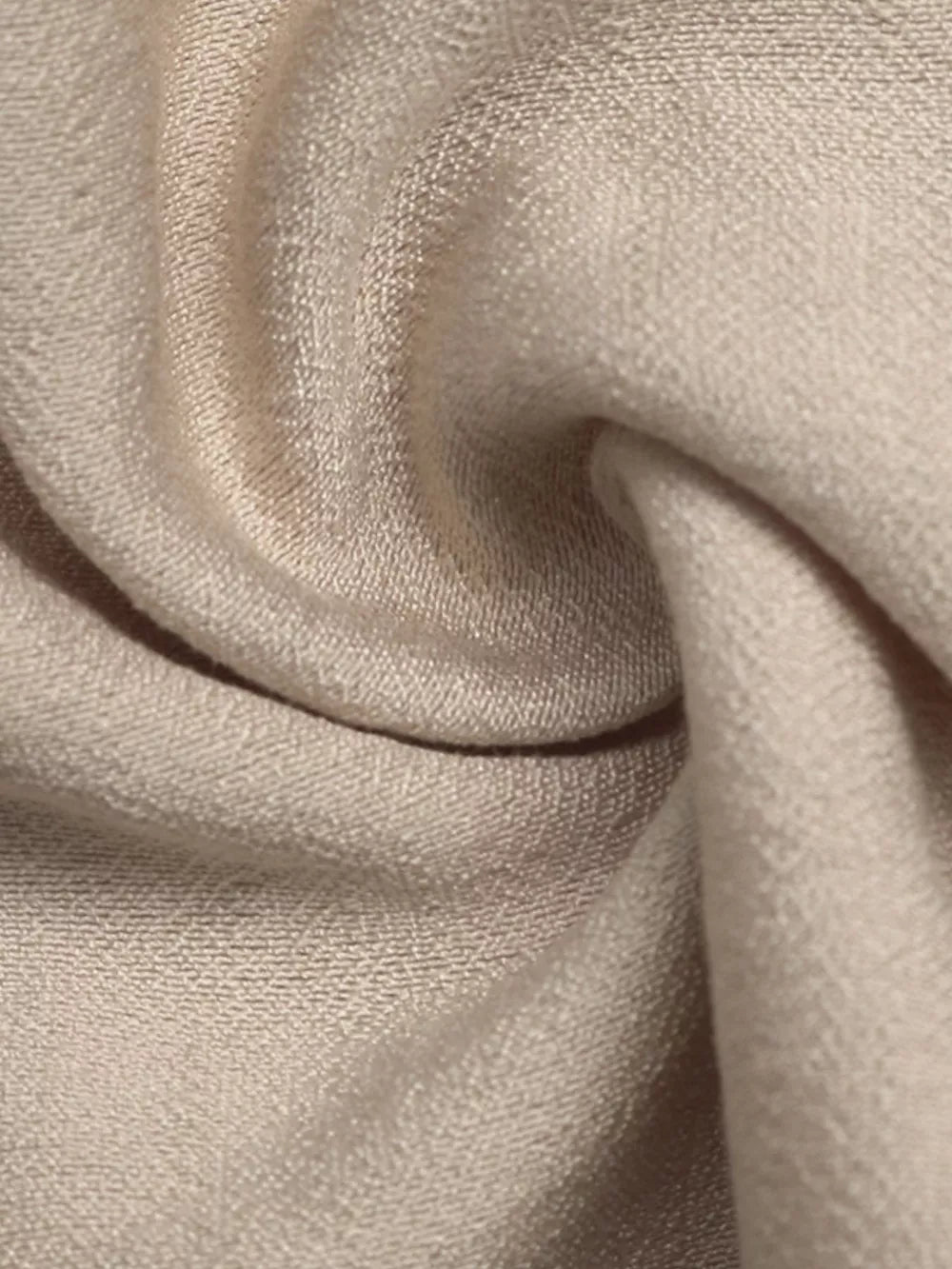 Elegant tied maxi dress in beige with textured fabric and piping detail.