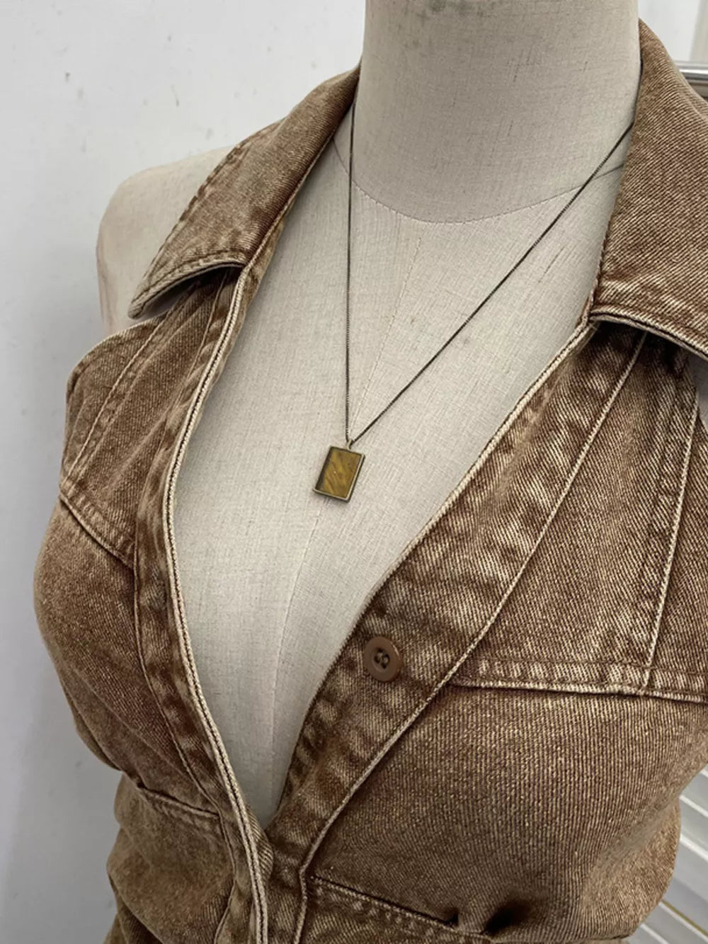 Khaki denim halter top with collar and button detail.