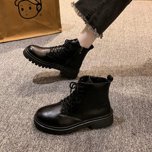 Black glossy leather combat booties with side zip and lace-up front.