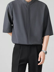 Dark gray oversized mandarin collar half-sleeve shirt with button-down front.