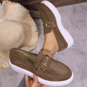 Brown loafers with gold horse-bit detail and white soles.