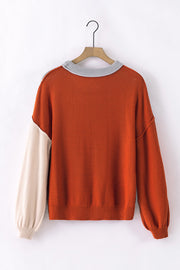 Orange and beige colorblock sweater with balloon sleeves and grey ribbed collar.