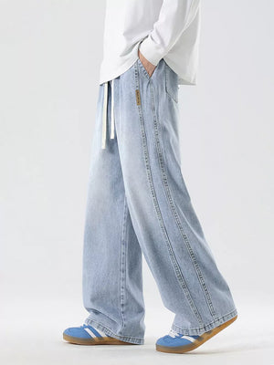 Oversized drawstring washed denim jeans in light blue with a relaxed fit and double-stitched seams.