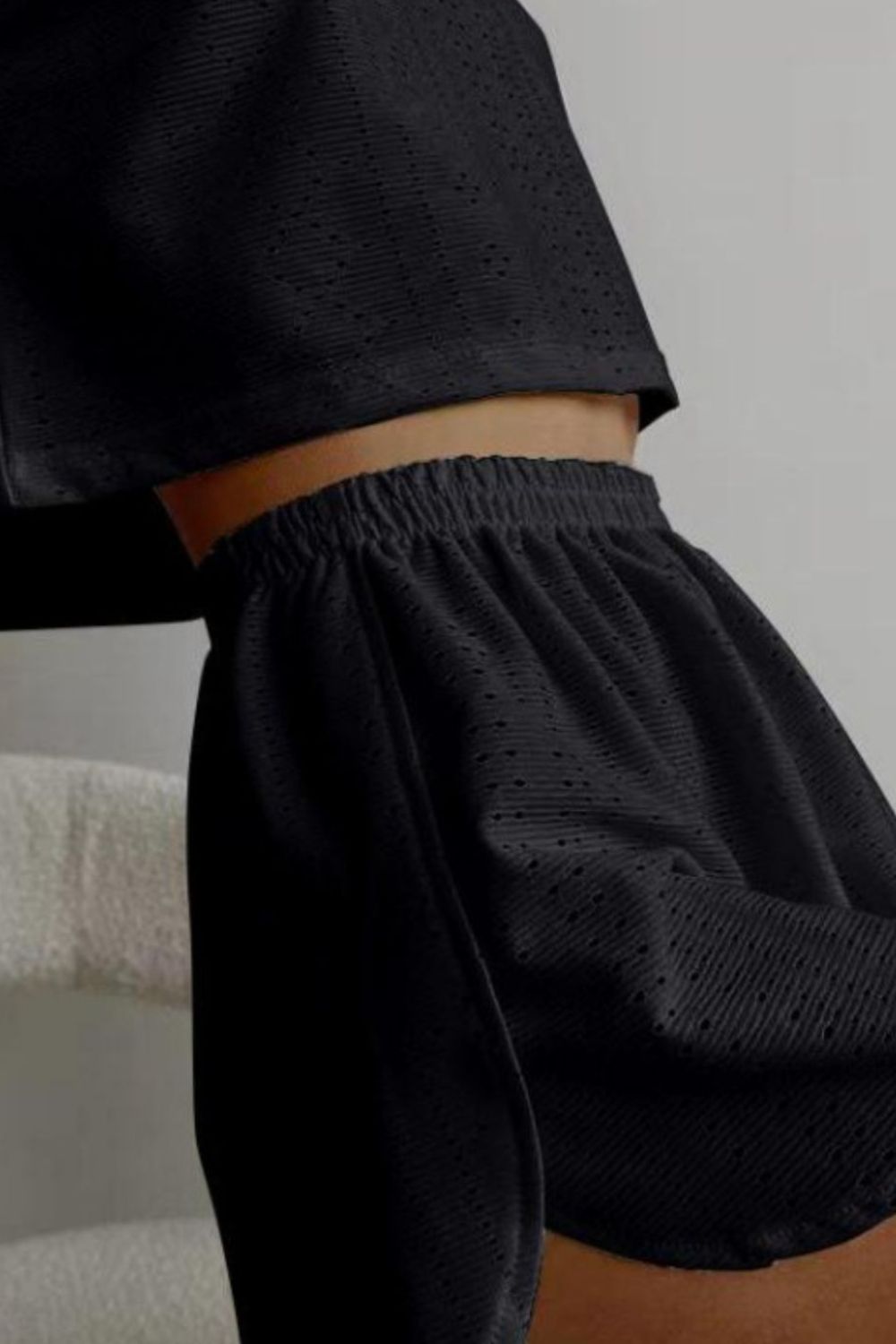 Black perforated crop top and shorts set with elastic waistband