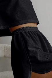 Black perforated crop top and shorts set with elastic waistband