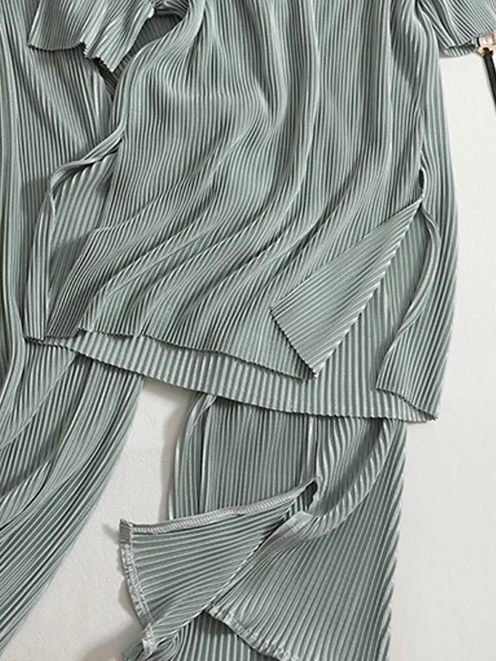 Elegant olive pleated two-piece set with side slits on top and pants.
