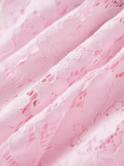 Powder pink floral lace dress detail showing intricate lace pattern and fabric texture.