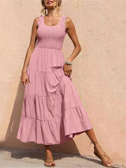 Smocked bodice ruffled maxi dress in blush pink with tiered skirt.