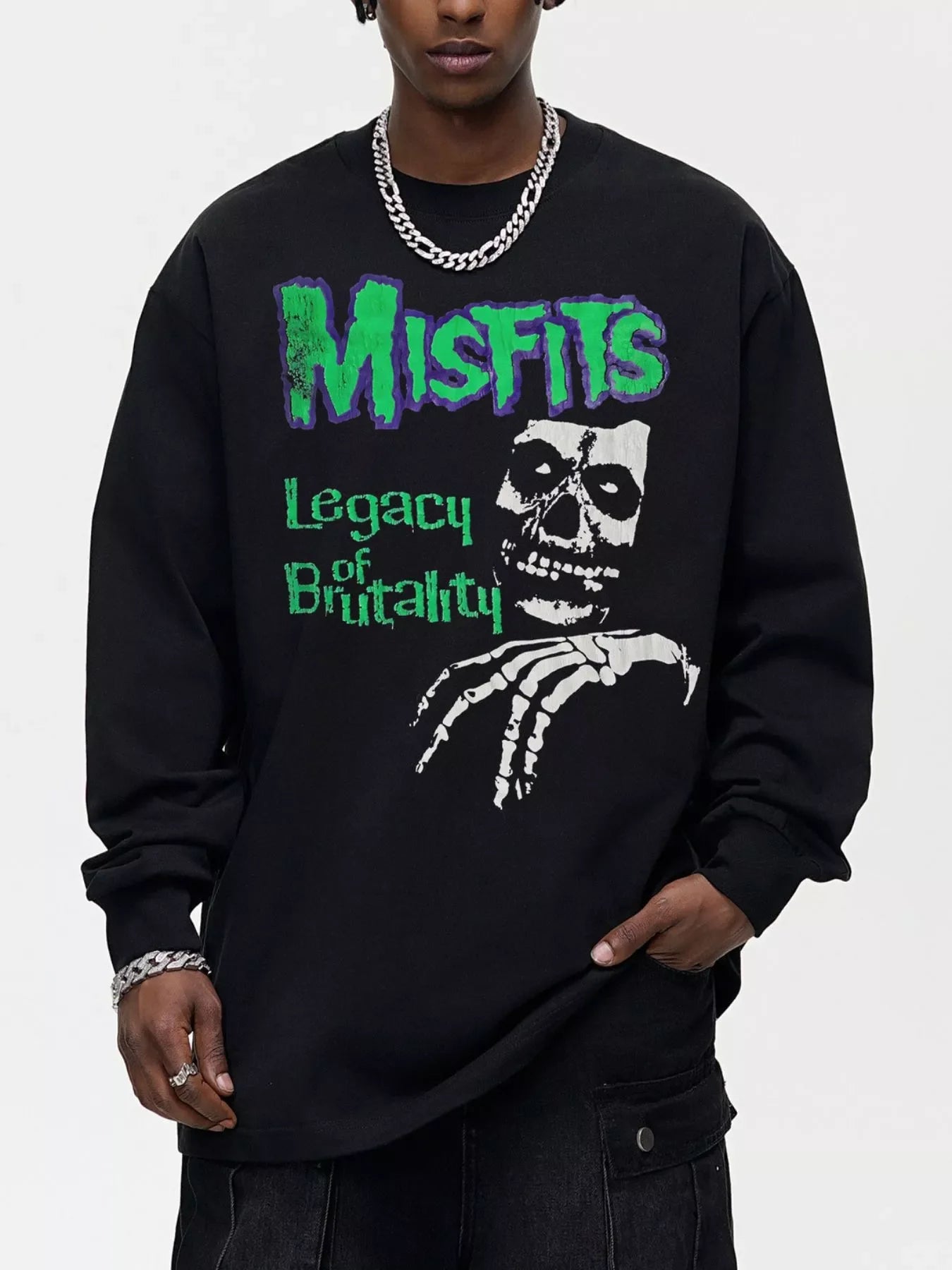 Black oversized long-sleeve sweatshirt with Misfits Legacy of Brutality skull graphic.