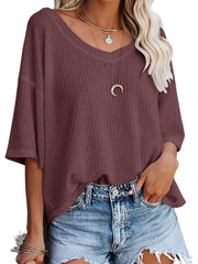 Maroon waffle knit relaxed v-neck t-shirt with short sleeves, styled with denim shorts.